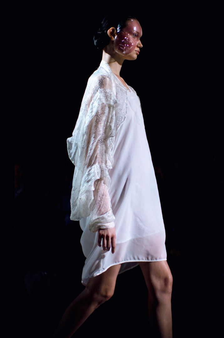 Fashion Artist Danny Roberts Photo of the profile of a model walking in a white Anrealage dress with a bubble mask in the Collection from Tokyo Fashion Week 2012