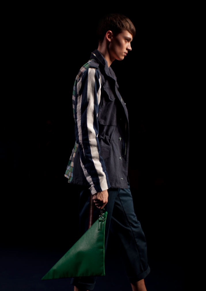 a profile of a model wearing a beige and yellow and red Trench Coat in Fashion Designer Phenomenon Spring 2012 Fashion Show Tokyo Fashion Week pictures by fashion photographer Danny Roberts